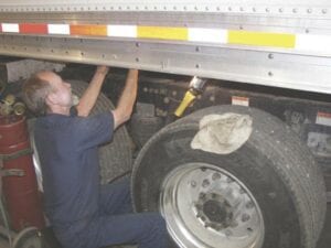 An auto mechanic working on a truck