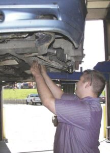 A mechanic repairing a vehicle